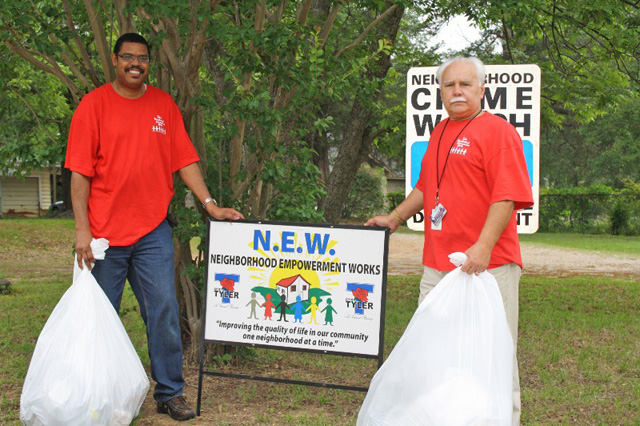 Two people holding trashbags